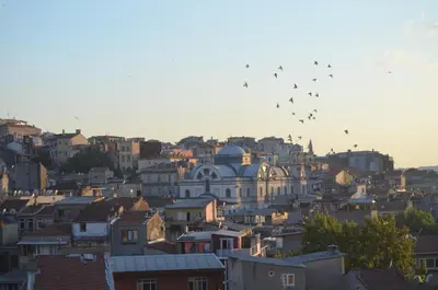 a group of birds flying in the sky over a city at Terra Suites in Istanbul