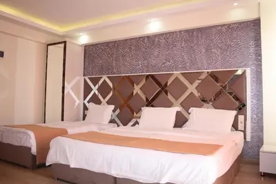 a bedroom with two beds and a large headboard at Terra Suites in Istanbul