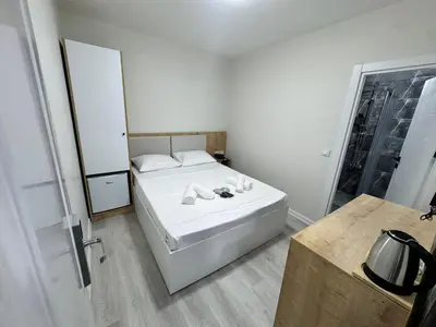 a small bedroom with a bed with towels on it at QLİNE HOTEL AİRPORT SaW in Istanbul