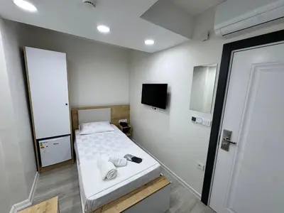 a small bedroom with a bed with towels on it at QLİNE HOTEL AİRPORT SaW in Istanbul