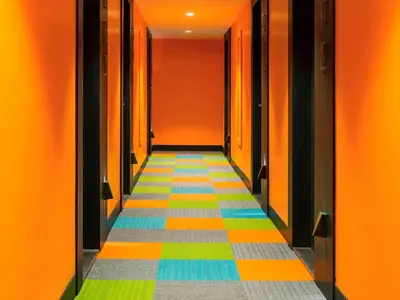 a hallway with colorful floors and orange walls at The Elysium Styles Taksim in Istanbul