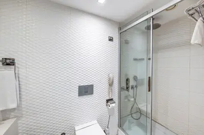 a bathroom with a shower with a glass door at The Elysium Styles Taksim in Istanbul