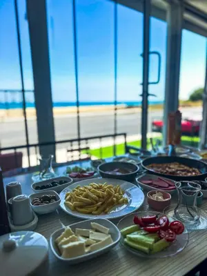 a table with plates of food on a table at İstanbul Airport Holiday Beach Hotel in Arnavutköy