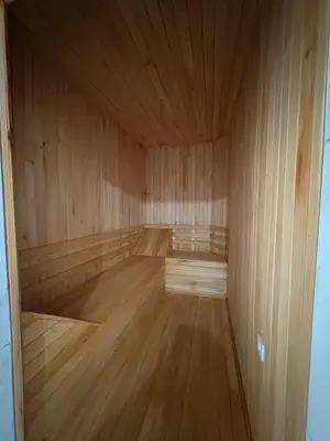 an empty sauna with wooden floors and a wooden ceiling at Villa in nature in Sapanca