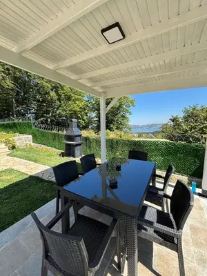 a patio with a table and chairs under a roof at Villa in nature in Sapanca