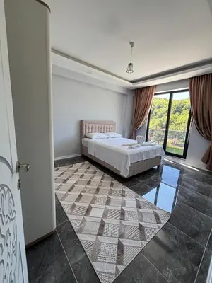 a bedroom with a bed and a large window at Villa in nature in Sapanca