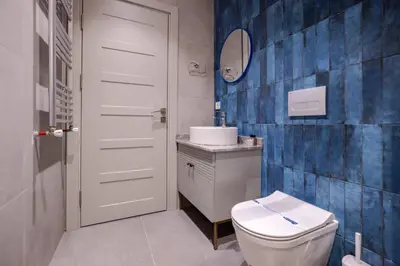 a bathroom with a white toilet and a sink at Amazing Luxury Duplex High Ceiling Patio! #403 in Istanbul