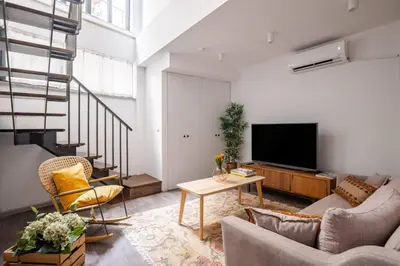 a living room with a couch and a tv at Amazing Luxury Duplex High Ceiling Patio! #403 in Istanbul