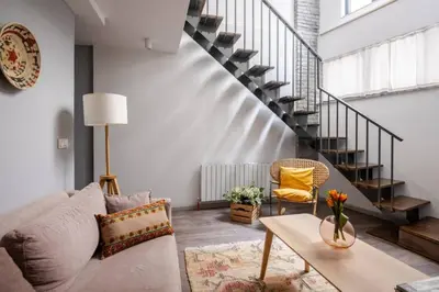 a living room with a couch and a table at Amazing Luxury Duplex High Ceiling Patio! #403 in Istanbul