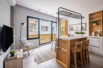 a living room with a kitchen with a table at Cozy Prime Location 1BD1Bath Sweet Home! #404 in Istanbul