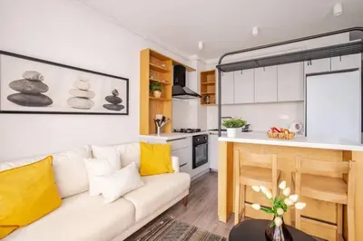 a living room with a couch and a kitchen at Cozy Prime Location 1BD1Bath Sweet Home! #404 in Istanbul