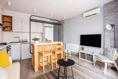 a kitchen and a living room with a table in a room at Cozy Prime Location 1BD1Bath Sweet Home! #404 in Istanbul