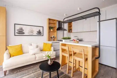 a living room with a couch and a kitchen at Cozy Prime Location 1BD1Bath Sweet Home! #404 in Istanbul