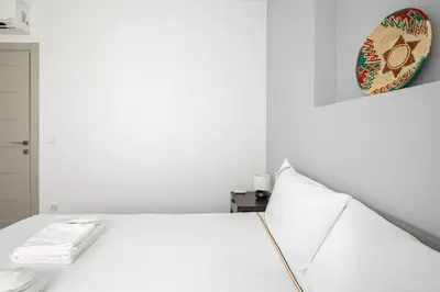 a white room with a bed and a plate on the wall at Cute Intimate Airy 1Bed1Bath Nisantasi Home! #405 in Istanbul