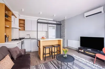 a kitchen and a living room with a couch and a table at Cute Intimate Airy 1Bed1Bath Nisantasi Home! #405 in Istanbul