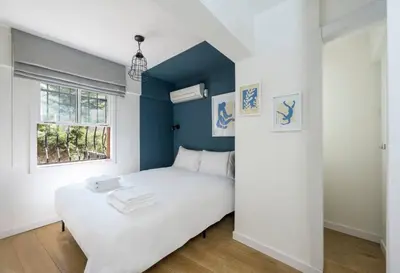 a bedroom with a white bed and a blue wall at Beautiful Modern Bright 2BD Patio Duplex #179 in Istanbul