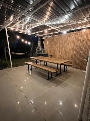 two picnic tables on a patio at night at Cozy 4BR Villa with Lake View and Comfort Galore in Sapanca