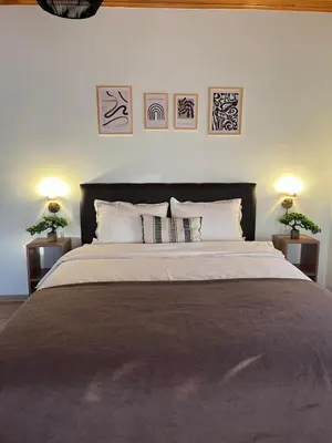 a bedroom with a large bed with two lamps at Cozy 4BR Villa with Lake View and Comfort Galore in Sapanca