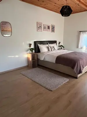 a bedroom with a large bed and a rug at Cozy 4BR Villa with Lake View and Comfort Galore in Sapanca