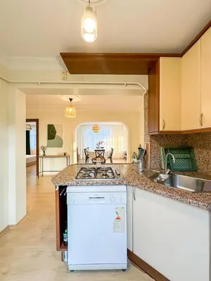 a kitchen with a sink and a stove top oven at Cozy 4BR Villa with Lake View and Comfort Galore in Sapanca
