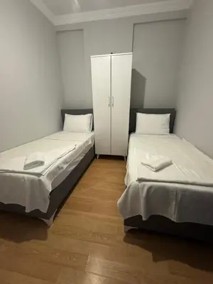 two beds in a small room with a cabinet at Disa - Hotel Galata in Istanbul