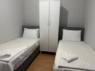 two beds sitting next to a cabinet in a room at Disa - Hotel Galata in Istanbul