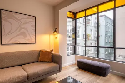 a living room with a couch and a large window at Galata 21 in Istanbul