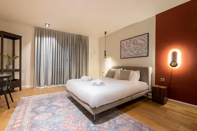 a bedroom with a large white bed and a table at Galata 21,1 in Istanbul