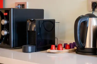 a microwave sitting on a counter next to a coffee maker at Galata 21,1 in Istanbul