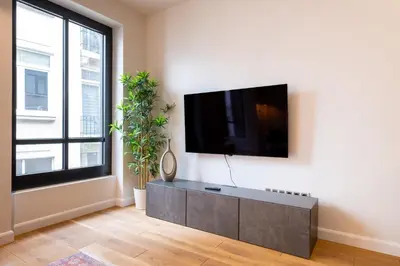 a living room with a flat screen tv on a wall at Galata 21,1 in Istanbul