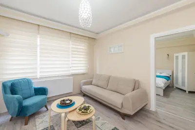 a living room with a couch and a chair and a table at White Rose Apart in Istanbul