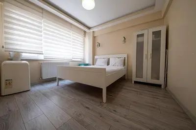 a bedroom with a bed and a window at White Rose Apart in Istanbul