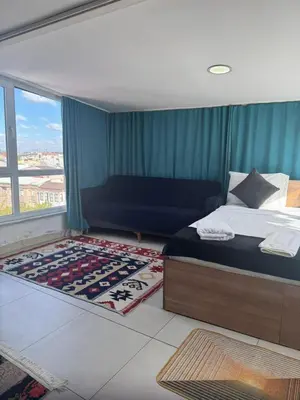 a bedroom with a bed and a rug on the floor at Lavina Apartment in Istanbul