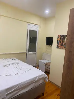 a bedroom with a white bed and a window at Muhterem Hanım Konağı in Istanbul