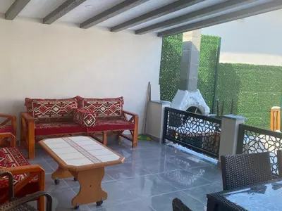 a living room with chairs and a fireplace at Villa منظر in Sapanca