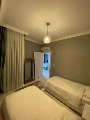 a bedroom with two beds and a mirror and a window at Villa منظر in Sapanca