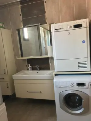 a small kitchen with a washing machine and a sink at Villa منظر in Sapanca
