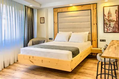 a bedroom with a wooden bed and a table at Vita Otel in Istanbul