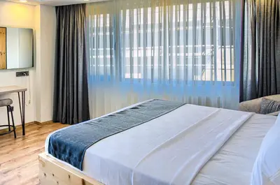 a bedroom with a bed and a large window at Vita Otel in Istanbul