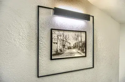 a picture hanging on a wall with a light at Vita Otel in Istanbul