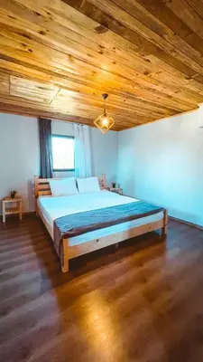 a large bed in a room with a wooden ceiling at Bambu dağ evi in Sapanca