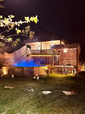 a house with a swimming pool at night at Bambu dağ evi in Sapanca