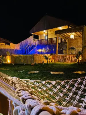 a house lit up at night with blue lights at Bambu dağ evi in Sapanca