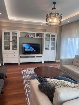 a living room with a couch and a tv at Villa Maya Serdivan in Serdivan