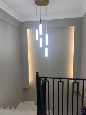 a chandelier hanging over a staircase in a house at Villa Maya Serdivan in Serdivan