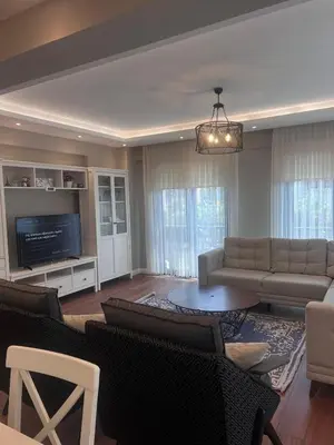 a living room with a couch and a tv at Villa Maya Serdivan in Serdivan