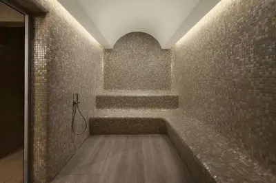 a bathroom with a bath tub with a tile wall at Marriott Executive Apartments Istanbul Tema World in Istanbul