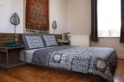 a bedroom with a bed and a rug on the wall at High Garden Rooftop Terrace Apartment Around Galata Tower in Istanbul