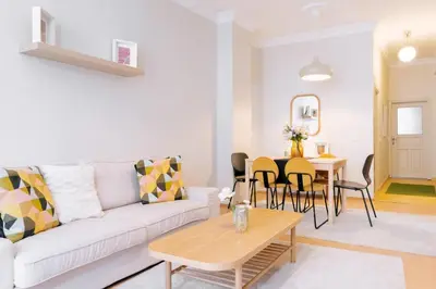 a living room with a white couch and a table at Upscale Apartments w Balcony - Near Istiklal in Istanbul