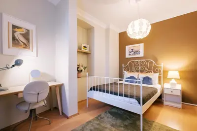 a bedroom with a bed and a desk and a chair at Upscale Apartments w Balcony - Near Istiklal in Istanbul
